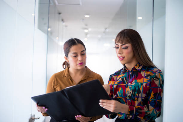 young woman and trans woman in the office