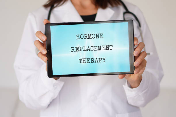 HORMONE REPLACEMENT THERAPY concept. words written on a tablet held in the hands of a female physician.